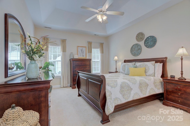 5748 Timbertop Ln, Charlotte, NC 28215 - carpeted bedroom featuring a tray ceiling and a ceiling fan