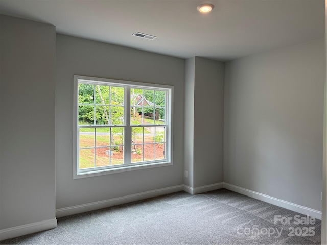 carpeted empty room with baseboards and recessed lighting