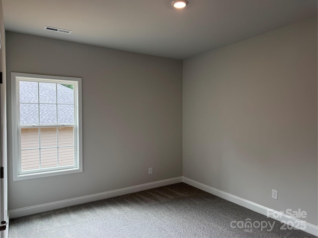 empty room with baseboards, carpet, and recessed lighting
