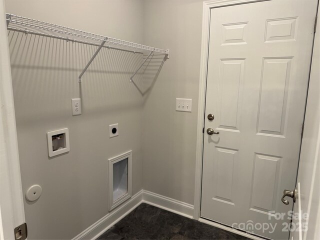 clothes washing area with hookup for a washing machine, electric dryer hookup, and baseboards