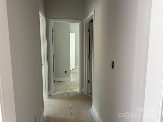 hallway featuring baseboards