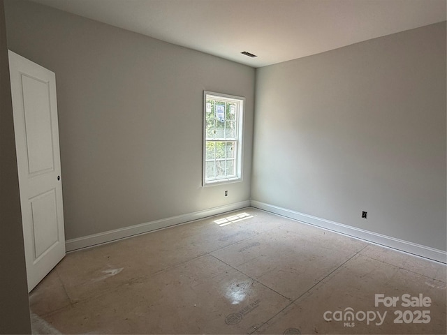 unfurnished room featuring baseboards