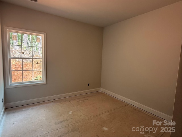 spare room with baseboards