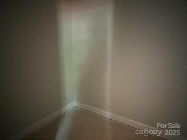 detailed view of baseboards and finished concrete flooring