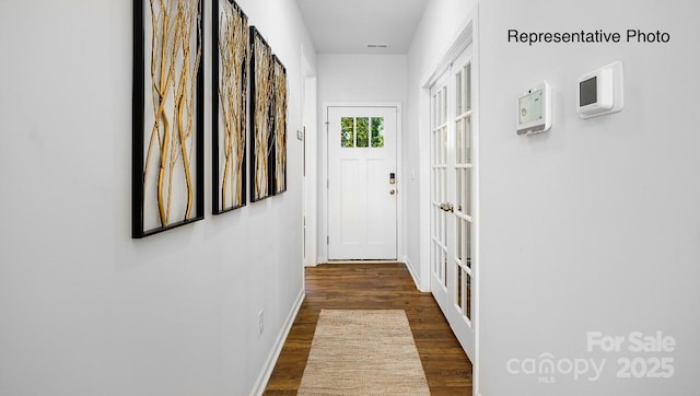 entryway with wood finished floors and baseboards