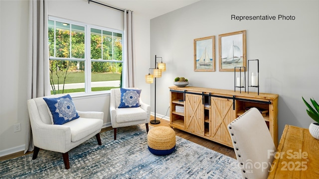 living area featuring wood finished floors and baseboards