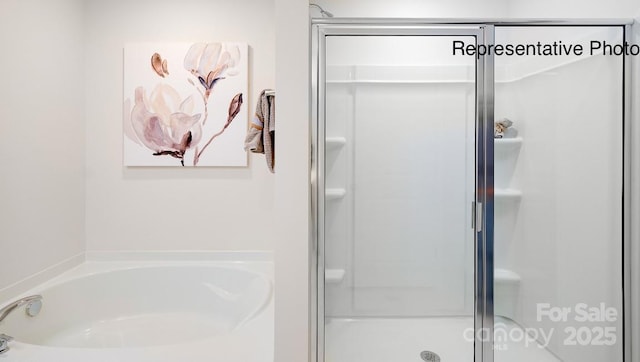 full bathroom featuring a stall shower and a bath