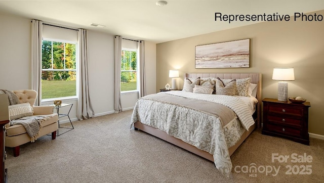 carpeted bedroom featuring baseboards