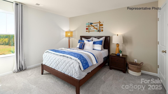 carpeted bedroom with baseboards