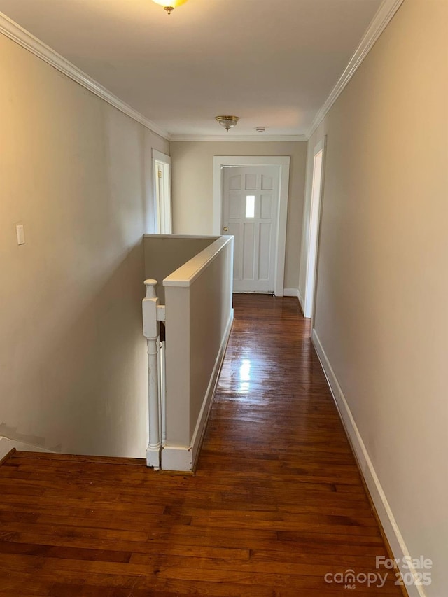 corridor with an upstairs landing, dark wood-style floors, crown molding, and baseboards