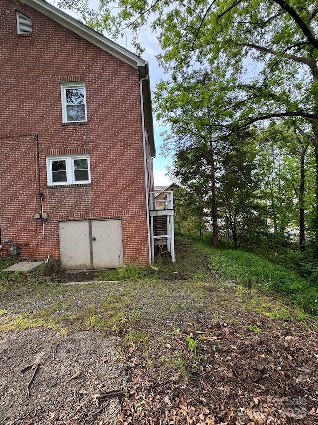 view of side of property with brick siding