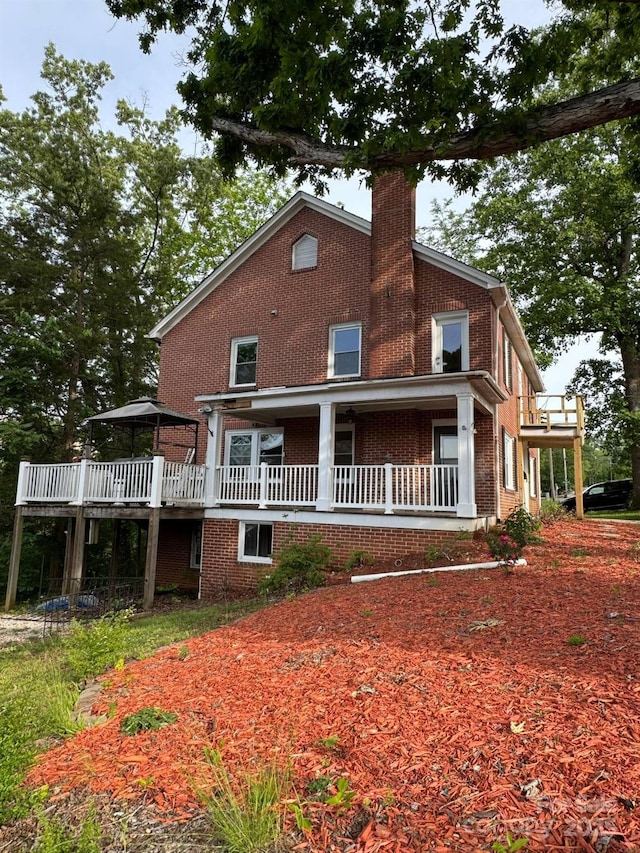 view of front of property with brick siding and a chimney