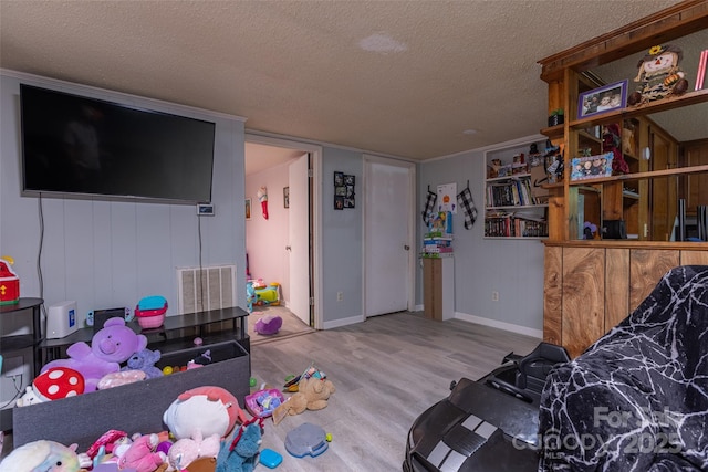 100 Lanier St, Mount Holly, NC 28120 - living area featuring a textured ceiling, wood finished floors, and baseboards