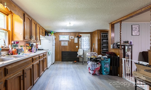 100 Lanier St, Mount Holly, NC 28120 - kitchen with white range, brown cabinets, a sink, light wood-style flooring, and plenty of natural light