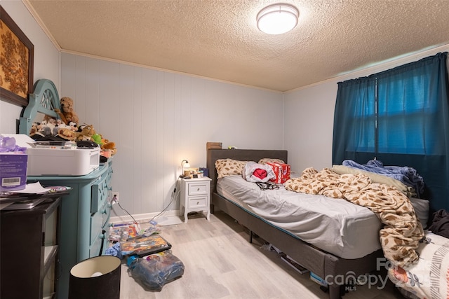 100 Lanier St, Mount Holly, NC 28120 - bedroom with light wood-style floors, ornamental molding, and a textured ceiling