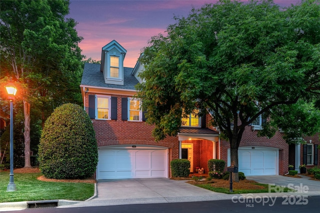 3128 Ethereal Ln, Charlotte, NC 28226 - view of front facade with brick siding, concrete driveway, an attached garage, and a standing seam roof