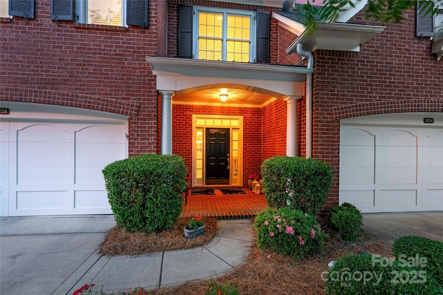 3128 Ethereal Ln, Charlotte, NC 28226 - property entrance with brick siding, concrete driveway, and an attached garage