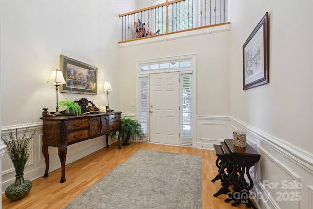 3128 Ethereal Ln, Charlotte, NC 28226 - entryway with wood finished floors, wainscoting, a towering ceiling, and a decorative wall