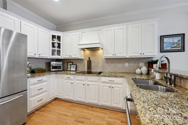 3128 Ethereal Ln, Charlotte, NC 28226 - kitchen featuring freestanding refrigerator, a sink, premium range hood, white cabinetry, and ornamental molding