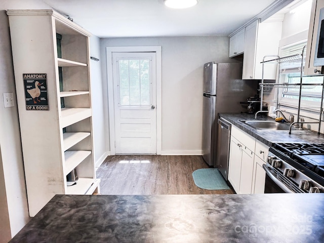 116 N Blue Ridge Ave, Hendersonville, NC 28792 - kitchen featuring stainless steel appliances, wood finished floors, open shelves, and baseboards