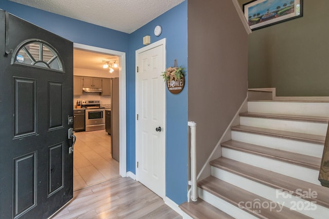 1739 Lesa Lin Dr, Monroe, NC 28112 - entrance foyer featuring stairway, a textured ceiling, and light wood-style floors