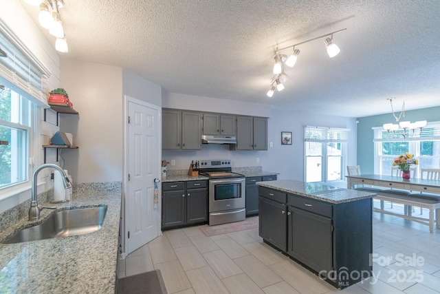 1739 Lesa Lin Dr, Monroe, NC 28112 - kitchen with stainless steel electric range oven, a sink, plenty of natural light, open shelves, and a textured ceiling