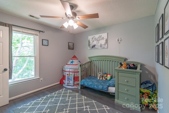1739 Lesa Lin Dr, Monroe, NC 28112 - bedroom featuring wood finished floors, a textured ceiling, a ceiling fan, and baseboards