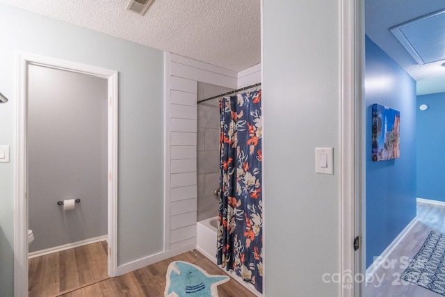 1739 Lesa Lin Dr, Monroe, NC 28112 - bathroom featuring wood finished floors, toilet, a textured ceiling, shower / tub combo, and baseboards