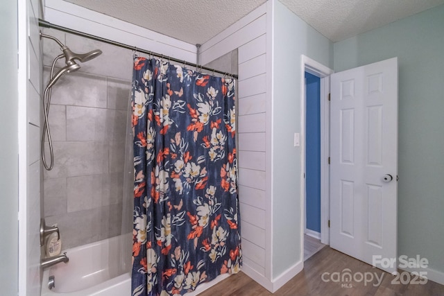 1739 Lesa Lin Dr, Monroe, NC 28112 - bathroom with a textured ceiling, wood finished floors, shower / tub combo, and baseboards