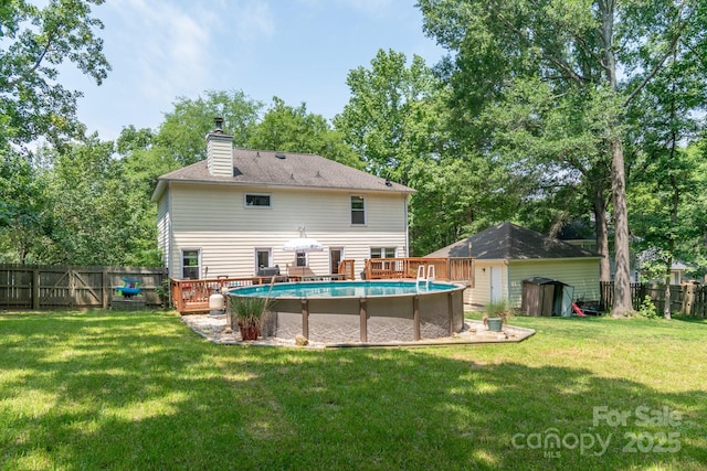 1739 Lesa Lin Dr, Monroe, NC 28112 - rear view of property with a chimney, a deck, and view of wooded area