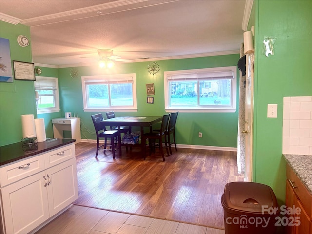 2601 Marldale St, Gastonia, NC 28052 - dining room featuring crown molding, wood finished floors, a ceiling fan, and baseboards