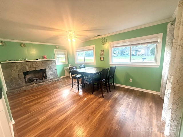 2601 Marldale St, Gastonia, NC 28052 - dining room featuring wood finished floors, a stone fireplace, ceiling fan, ornamental molding, and baseboards