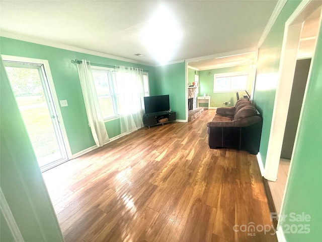 2601 Marldale St, Gastonia, NC 28052 - living area featuring wood finished floors, crown molding, plenty of natural light, and baseboards