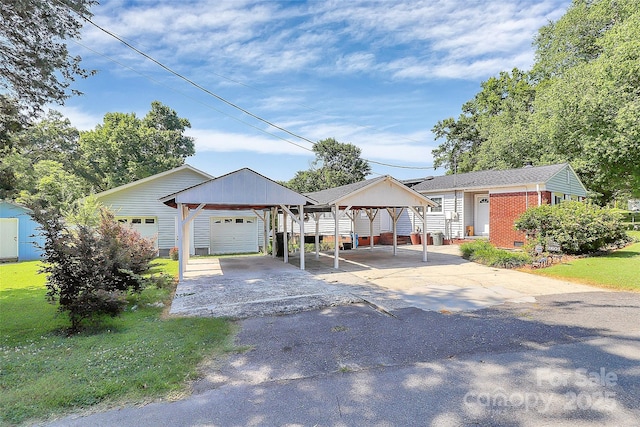 2601 Marldale St, Gastonia, NC 28052 - view of front of house with asphalt driveway, a detached garage, a carport, and a front lawn