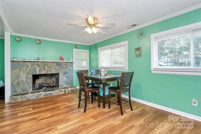 2601 Marldale St, Gastonia, NC 28052 - dining room featuring ceiling fan, wood finished floors, crown molding, and a stone fireplace