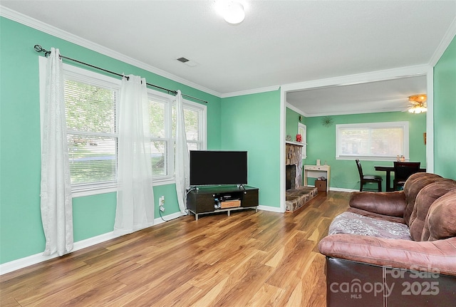2601 Marldale St, Gastonia, NC 28052 - living area with wood finished floors, crown molding, a stone fireplace, and plenty of natural light