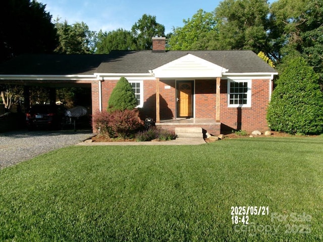 2357 28th St NE, Hickory, NC 28601 - ranch-style house with a chimney, brick siding, a carport, driveway, and a front lawn