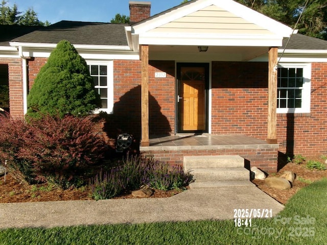 2357 28th St NE, Hickory, NC 28601 - property entrance with a chimney, brick siding, and a shingled roof