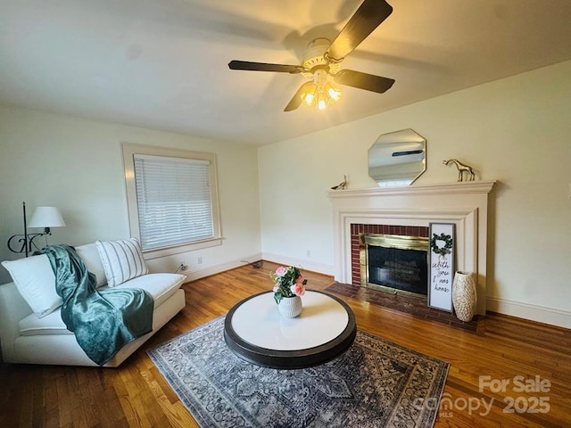 2357 28th St NE, Hickory, NC 28601 - living area with a brick fireplace, wood finished floors, baseboards, and a ceiling fan