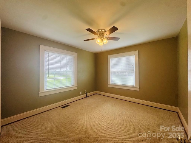 2357 28th St NE, Hickory, NC 28601 - spare room featuring carpet flooring, baseboards, and a ceiling fan