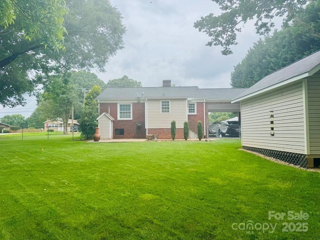 2357 28th St NE, Hickory, NC 28601 - back of house with brick siding, a lawn, and a chimney