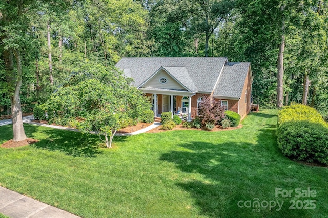 122 Waterford Dr, Mooresville, NC 28117 - neoclassical / greek revival house with covered porch, brick siding, a front yard, and roof with shingles