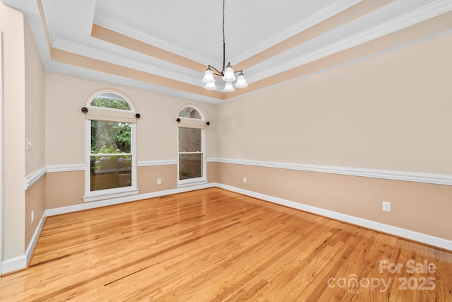 122 Waterford Dr, Mooresville, NC 28117 - spare room with wood finished floors, baseboards, crown molding, a chandelier, and a raised ceiling