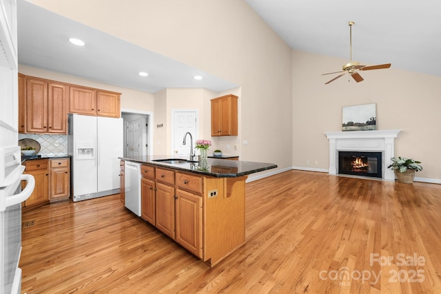 122 Waterford Dr, Mooresville, NC 28117 - kitchen with white fridge with ice dispenser, a sink, dishwashing machine, light wood-style flooring, and vaulted ceiling