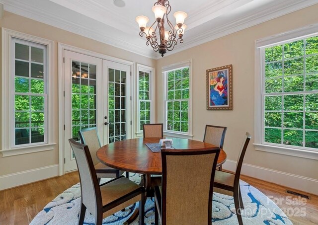 dining room with french doors, baseboards, wood finished floors, and ornamental molding
