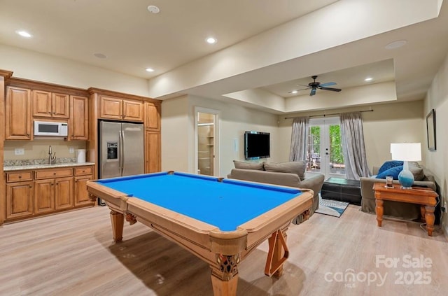 game room with light wood-style floors, billiards, ceiling fan, a tray ceiling, and recessed lighting