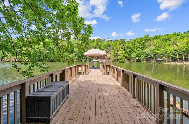 wooden deck featuring a gazebo and a water view