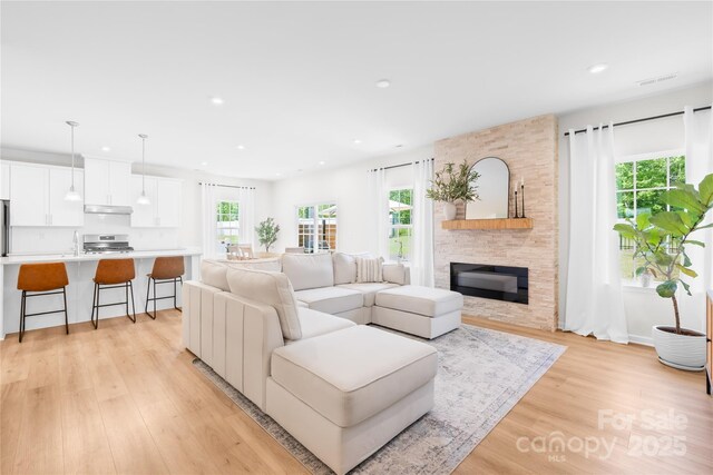 3110 Streamside Dr, Davidson, NC 28036 - living room with plenty of natural light, light wood-style flooring, recessed lighting, a fireplace, and baseboards