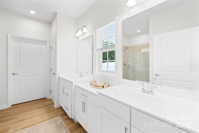 3110 Streamside Dr, Davidson, NC 28036 - bathroom with a shower stall, wood finished floors, vanity, and recessed lighting