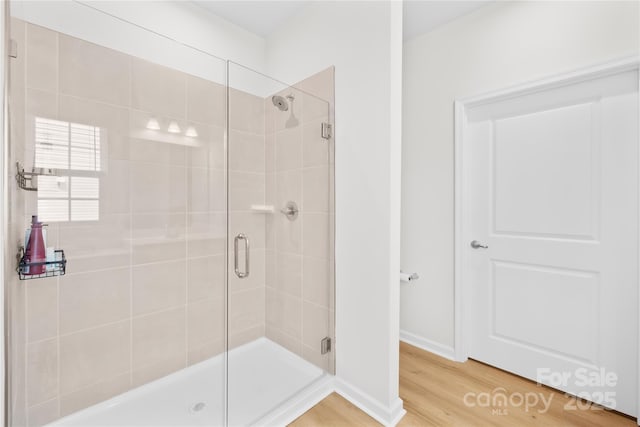 3110 Streamside Dr, Davidson, NC 28036 - bathroom featuring a stall shower, wood finished floors, and baseboards